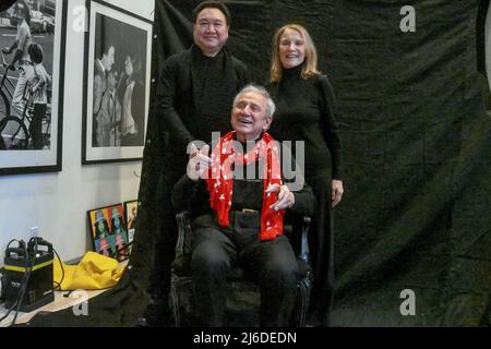 MONTVILLE, NEW JERSEY, USA, JANUARY, 5th 2017 Photo shoot at Ron Galella's Home. Ron Galella, during a recent photo shoot at his home. Standing behind Ron is Zhong Weixing a Chinese collector of art and photographs along with Elaine Laffont the founder of Sygma photo agency  On the left  on display is one of Ron's other famous photographs of Bruce Springsteen Bob Dylan and Mick Jagger at the Rock and Roll Hall of Fame in New York Stock Photo