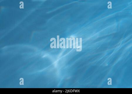 Caustic effect light refraction on blue wall overlay photo mockup, blurred sun rays refracting through glass prism with shadow. Abstract natural light Stock Photo