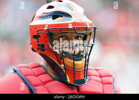 St. Louis Cardinals catcher Yadier Molina adjusts his mask as he