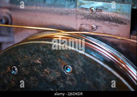 Copper wire straightener machine tool in plant workshop Stock Photo