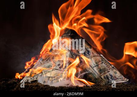 The concept of exchange in financial markets is the collapse of the financial system of capitalism. collapse of a financial pyramid, dollars are burni Stock Photo