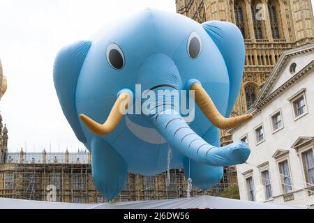 April 27, 2022, London, United Kingdom: A balloon depicting an elephant flies over Parliament Square during a protest in College Green. Animal rights activists erected two large inflatable balloons in the shape of a lion and an elephant in support of the Animal Protection Bill that is currently before Parliament. The bill would ban the imports of Foie Gras as well as hunting trophies, and the promotion of elephant tourist rides overseas (Credit Image: © Tejas Sandhu/SOPA Images via ZUMA Press Wire) Stock Photo