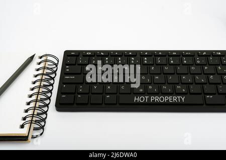 Conceptual caption Hot Property. Concept meaning Something which is sought after or is Heavily Demanded Computer Keyboard And Symbol.Information Stock Photo