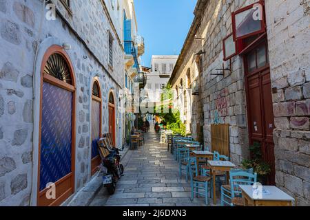 Ermoupoli, Greece - July 6, 2021: Typical Mediterranean narrow street alley on the Greek island of Syros. Located in the Aegean Sea in the Cyclades ar Stock Photo