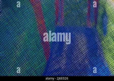 Blue plastic fine mesh close-up on the background of the playground. Backdrop background. Stock Photo