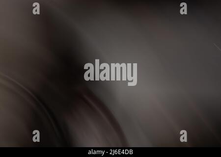 Black gray abstract background with a warm tint. Banner with a smooth gradient from dark to light tones, lines and waves. Backdrop Stock Photo