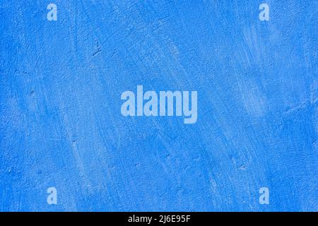Beautiful grunge blue plaster wall background. Banner made of concrete texture in blue colors. Place for text for entries. Stock Photo