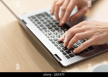 Business man using laptop sitting at desk in office Stock Photo