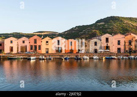 Picturesque Bosa - colourful historic tanner's houses in a row on the waterfront of the Temo in the old town glow in the sun, Planargia, Sardinia Stock Photo