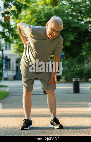 Old man suffering from lower back pain Stock Photo - Alamy
