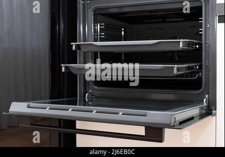 new electric oven built in with trays on telescopic rails Stock Photo