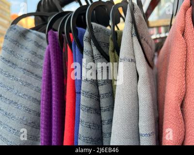 scarf, colorful trendy and fashionable scarves hanging on rack in a cloth store. fashion concept photo with selective focus Stock Photo