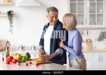 Loving husband making dinner for his beautiful wife Stock Photo