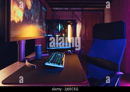 Professional gaming PC setup in neon room Stock Photo