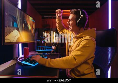 Pro gamer streamer feel exited while participating in online tournament Stock Photo