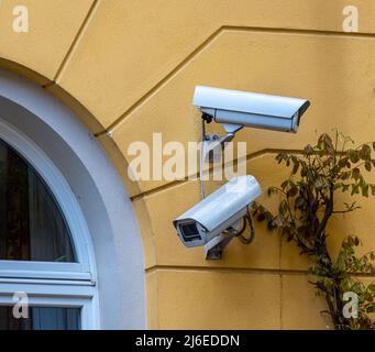 security camera or surveillance system on a house wall Stock Photo