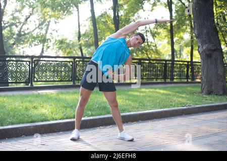 active man in sportswear making stretching exercise Stock Photo