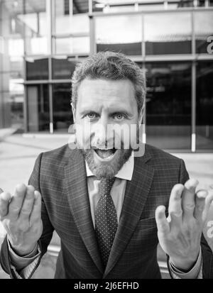cheerful emotional bearded businessman in formal suit gesturing, emotional Stock Photo