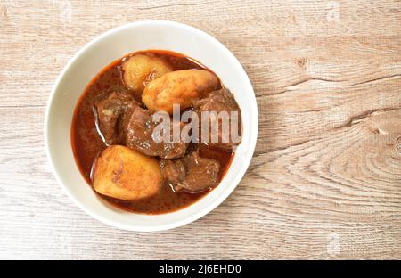 beef meat massaman curry with slice potato and onion in bowl Stock Photo