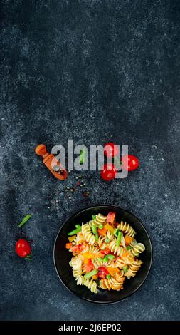 Penne pasta with vegetables, asparagus, peas, bell pepper, tomato ...