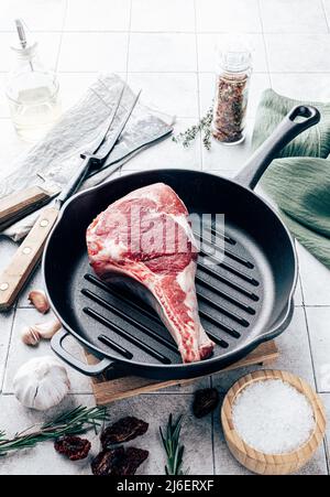 Tomahawk steak on grill pan. Cooking concept Stock Photo