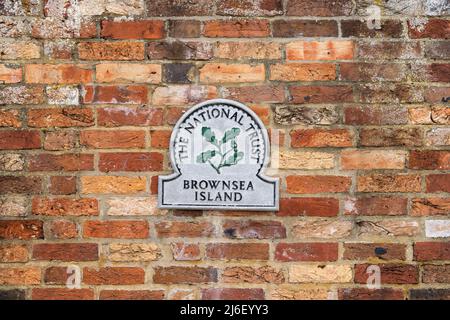 Poole, Dorset, United Kingdom - April 14 2022: National Trust Brownsea Island plaque mounted on the outer walls of the island Stock Photo