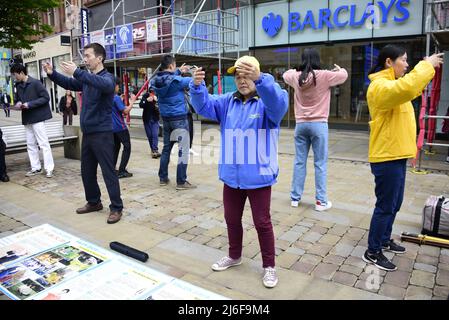 Manchester, UK, 1st May, 2022. Protest by Falun Gong meditation  practitioners, Market Street, central Manchester, England, United Kingdom, British Isles. The group handed out leaflets alleging that, in China, Falun Gong meditation practitioners were among those who had their organs forcefully removed for profit as they are considered to live a healthy lifestyle. Credit: Terry Waller/Alamy Live News Stock Photo