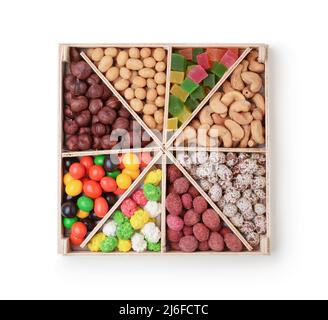 Set of nuts in a wooden box isolated on white. Top view. Stock Photo