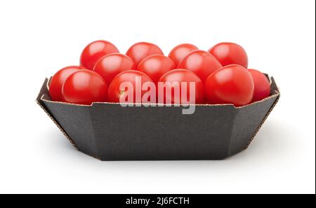 Ripe cherry tomatoes in a cardboard box isolated on white. Stock Photo