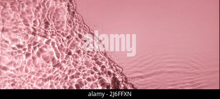 abstract water wave surface texture on pink background with copy space. banner Stock Photo