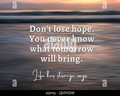 Inspirational quote - Don't lose hope. You never know what tomorrow will bring. With blurry beach background in digital motion effect and bright smoot Stock Photo