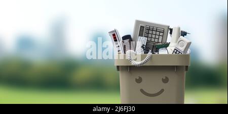 Recycling bin full of electronic waste, smiling cute character Stock Photo