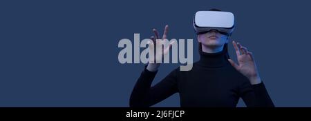 Woman wearing a VR headset and interacting with virtual reality interfaces Stock Photo