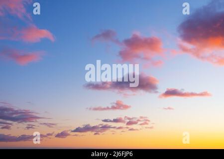 Colorful individual clouds in the sky at sunset. Gradient color. Sky texture, abstract nature background Stock Photo