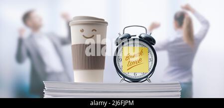 Business people taking a break in the office, alarm clock with sticky note in the foreground Stock Photo