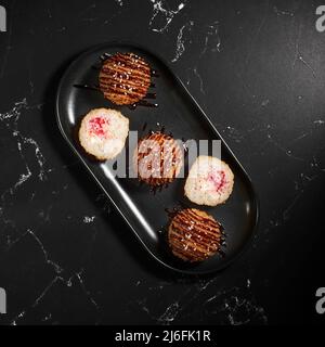 Rice croquettes with tiger shrimp. Cheese cream, tobiko caviar, tiger prawns.. Deep-fried. Sushi menu. Close up Stock Photo