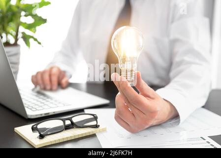 Business, creative idea concept. Businessman holding light bulb Stock Photo