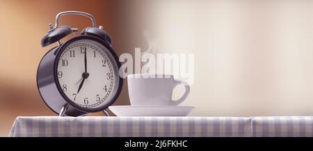 Vintage alarm clock and hot coffee on the kitchen table Stock Photo