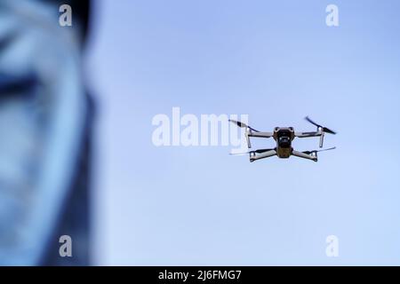 Drone flying in the blue sky on a clear sky morning. Stock Photo