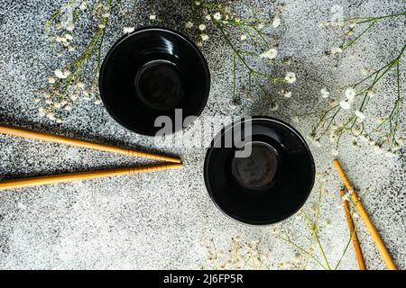 Asian spring table setting with  gypsophila flowers served on the modern concrete table Stock Photo