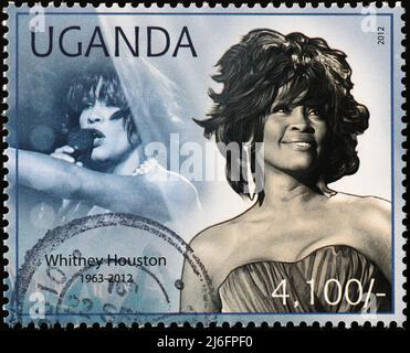 Portraits of Whitney Houston on stamp of Uganda Stock Photo