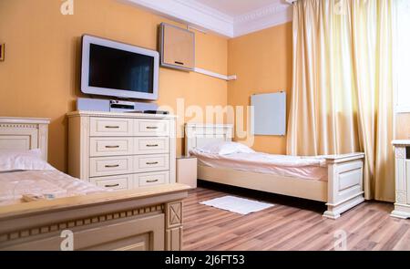 double hotel room. two beds and a TV in a classic hotel. Stock Photo