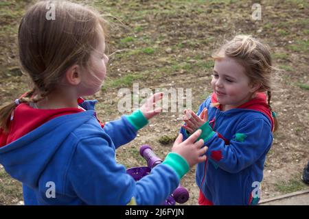 Kids playing Pat a Cake game, UK Stock Photo