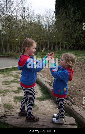 Kids playing Pat a Cake game, UK Stock Photo