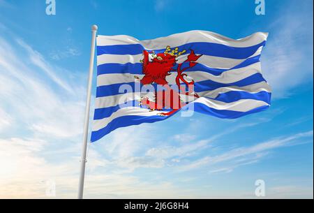 official flag of Official Province of Luxembourg, Belgium at cloudy sky background on sunset, panoramic view. Belgian travel and patriot concept. copy Stock Photo