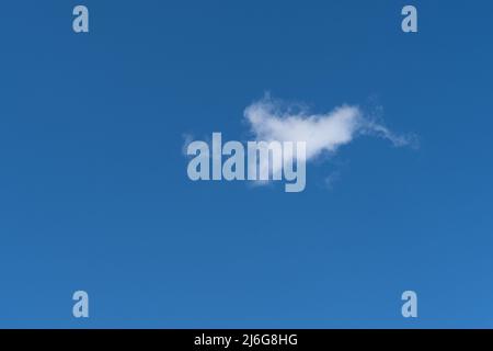 A single cloud in a blue sky Stock Photo