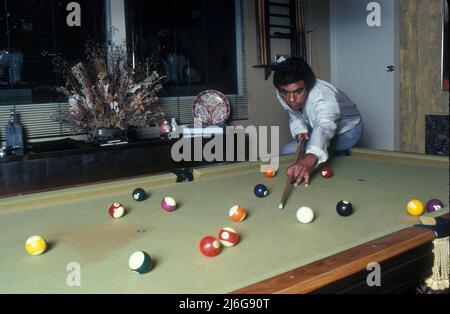 July 1, 1981, Hollywood, California, USA: American pop singer JOHNNY MATHIS, 45, playing with his pool table at home. John Royce Mathis (born September 30, 1935) American singer of popular music. Startied career with singles of standard music, became highly popular as an album artist, with several dozen of his albums achieving gold or platinum status and 73 making the Billboard charts. Sold over 400 million records worldwide to date and makes him the third-biggest selling artist of the 20th century after Presley and Sinatra. Received the Grammy Lifetime Achievement Award and has been inducted Stock Photo