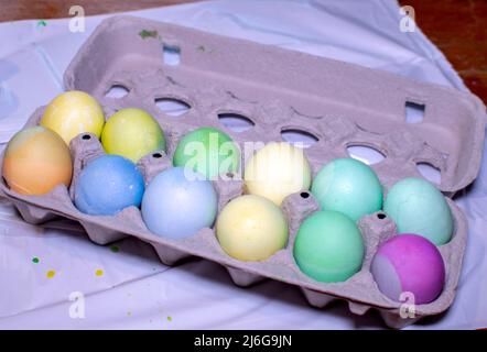 Fresh dyed easter eggs are put back in the carton for easy storage until easter day Stock Photo