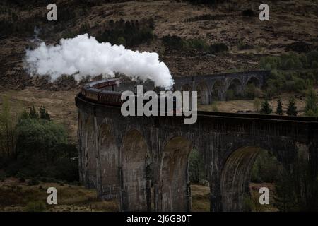 The Jacobite steam train on the Glenfinnan viaduct, Glenfinnan, Scotland, UK, as seen in Harry Potter Stock Photo