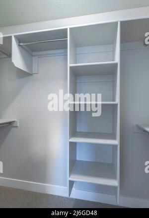 White windowless walk-in closet with tall cabinet in the middle Stock Photo  - Alamy